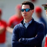 Craig Breslow (left), chief baseball officer of the Boston Red Sox, watches pitchers work out during spring training at JetBlue Park.