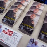 Campaign flyers and books by Republican John Deaton, who faces incumbent U.S. Sen. Elizabeth Warren, D-Mass., are displayed at a campaign stop at American Legion Post 302, Wednesday, Oct. 9, 2024, in Rehoboth, Mass.
