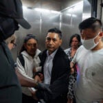Immigration and Customs Enforcement agents pull a man out of an elevator as he and his daughter attempt to leave following a hearing in immigration court.