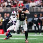 Falcons wide receiver Drake London catches a pass with separation from a defender behind him.