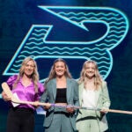 Haley Winn, center, poses for a photo after the Boston Fleet selected her during the first round of the PWHL draft in Ottawa, Ontario, Tuesday, June 24, 2025.