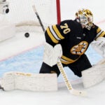 Boston Bruins goaltender Joonas Korpisalo (70) fails to block the puck during the first period of an NHL hockey game against the New York Rangers, Friday, Nov. 28, 2025, in Boston.