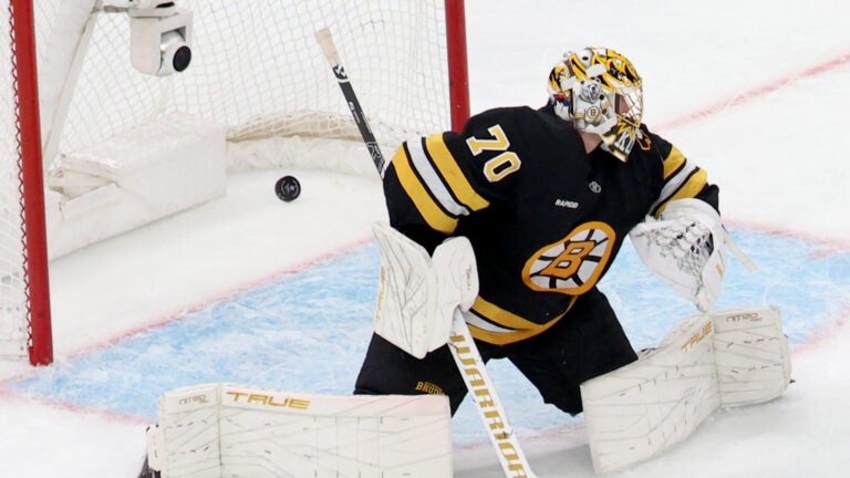 Boston Bruins goaltender Joonas Korpisalo (70) fails to block the puck during the first period of an NHL hockey game against the New York Rangers, Friday, Nov. 28, 2025, in Boston.