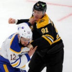 Boston Bruins Nikita Zadorov (91) and Buffalo Sabres Jordan Greenway (12) mix it up during first period NHL action at TD Garden.