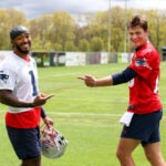 riots player Ja'Lynn Polk (cq) left and QB Drake Maye (cq) right share a laugh at the Patriots 2024 Rookie Mini-Camp.
